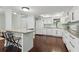 Well-lit kitchen features stainless steel appliances, sleek white cabinets, and granite counters at 2033 Arbor Dr, Clearwater, FL 33760