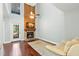 Bright living room with a stone fireplace and hardwood floors creating a cozy and inviting atmosphere at 2033 Arbor Dr, Clearwater, FL 33760