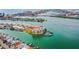 Scenic aerial view of waterfront condos with private docks and access to open water, with city in background at 205 Brightwater Dr # 101, Clearwater Beach, FL 33767