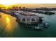 Aerial view of a waterfront condo with boat docks, with expansive views of the Intracoastal Waterway and stunning sunset backdrop at 205 Brightwater Dr # 101, Clearwater Beach, FL 33767
