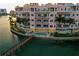 Aerial view of a waterfront condo building featuring an outdoor pool and dock at 205 Brightwater Dr # 101, Clearwater Beach, FL 33767