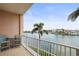 Relaxing balcony with seating offers panoramic waterfront views of the bay and palm trees at 205 Brightwater Dr # 101, Clearwater Beach, FL 33767