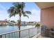 Balcony view of the waterfront with palm trees and neighborhood houses at 205 Brightwater Dr # 101, Clearwater Beach, FL 33767