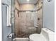 Modern bathroom with tiled walk-in shower, glass door and convenient shower caddy at 205 Brightwater Dr # 101, Clearwater Beach, FL 33767