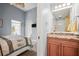 Comfortable bedroom with blue walls, ceiling fan, and attached bathroom vanity at 205 Brightwater Dr # 101, Clearwater Beach, FL 33767