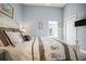 Comfortable bedroom featuring a large window, ceiling fan, a walk-in closet, and calm paint at 205 Brightwater Dr # 101, Clearwater Beach, FL 33767