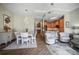 Open dining area showcases hardwood floors, natural light, comfortable seating, and an adjacent kitchen at 205 Brightwater Dr # 101, Clearwater Beach, FL 33767