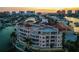 Luxury waterfront condo building with private balconies, swimming pool, lush landscaping, and private boat docks at 205 Brightwater Dr # 101, Clearwater Beach, FL 33767