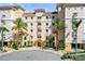 Luxury condo with lush landscaping, palm trees, and covered entry at 205 Brightwater Dr # 101, Clearwater Beach, FL 33767