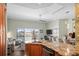 Open-concept kitchen with island seating area, granite countertops, modern appliances, and water views at 205 Brightwater Dr # 101, Clearwater Beach, FL 33767