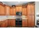 Kitchen features granite counters, mosaic tile backsplash, stainless steel appliances and lots of wooden cabinets at 205 Brightwater Dr # 101, Clearwater Beach, FL 33767