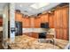 Kitchen featuring granite countertops, stainless appliances and skylight, connecting to other living spaces at 205 Brightwater Dr # 101, Clearwater Beach, FL 33767