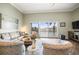 Bright living room with comfortable seating, stylish decor, and a large sliding glass door with a water view at 205 Brightwater Dr # 101, Clearwater Beach, FL 33767