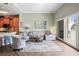 Open living room with a sofa, chairs, rug, and a sliding glass door providing access to the balcony at 205 Brightwater Dr # 101, Clearwater Beach, FL 33767