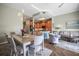 Open concept kitchen, living, and dining area with modern lighting and stylish furniture at 205 Brightwater Dr # 101, Clearwater Beach, FL 33767