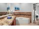 Comfortable main bathroom features a soaking tub, an undermount sink, and tile accents at 205 Brightwater Dr # 101, Clearwater Beach, FL 33767