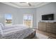 Bright main bedroom features light hardwood floors, tray ceilings, and access to a walk-out balcony at 205 Brightwater Dr # 101, Clearwater Beach, FL 33767