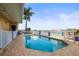 Outdoor pool with brick border with view of the inter-coastal waters at 205 Brightwater Dr # 101, Clearwater Beach, FL 33767