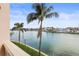 Water view overlooking a calm bay with waterfront homes and palm trees at 205 Brightwater Dr # 101, Clearwater Beach, FL 33767