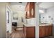 Elegant wet bar featuring wood cabinetry, granite countertops, and stylish fixtures adjacent to a bath at 205 Brightwater Dr # 101, Clearwater Beach, FL 33767