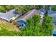 Aerial view of a charming blue house with lush greenery and a detached garage at 207 W Chelsea St, Tampa, FL 33603