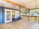 Relaxing covered back porch with comfortable seating, perfect for enjoying outdoor living and entertaining at 207 W Chelsea St, Tampa, FL 33603