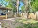 Spacious backyard with deck, wooden fence, and mature trees at 207 W Chelsea St, Tampa, FL 33603
