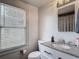 Well-lit bathroom features a modern vanity with granite countertop and brushed nickel fixtures at 207 W Chelsea St, Tampa, FL 33603