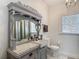 Charming bathroom vanity with decorative mirror, stylish lighting, and tiled countertop in a well-lit space at 207 W Chelsea St, Tampa, FL 33603