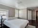 Bedroom with white linens, rug, dark wood floor, two windows, and a doorway at 207 W Chelsea St, Tampa, FL 33603