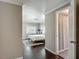 Bedroom view into bathroom showcasing hardwood floors, neutral walls, and a minimalist aesthetic at 207 W Chelsea St, Tampa, FL 33603