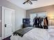 Sunlit bedroom with hardwood floors, ceiling fan, and a comfortable bed with a throw blanket at 207 W Chelsea St, Tampa, FL 33603
