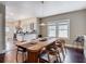 Bright dining room featuring a long wooden table, stylish chairs, hardwood floors, and view to the kitchen at 207 W Chelsea St, Tampa, FL 33603