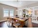 Bright dining room featuring a long wooden table, stylish chairs, and hardwood floors with open view to living room at 207 W Chelsea St, Tampa, FL 33603