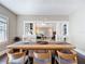 Dining room featuring a long wooden table, stylish chairs, and hardwood floors with open view to living room at 207 W Chelsea St, Tampa, FL 33603