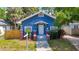 Charming blue bungalow with a welcoming front porch and well-manicured lawn, offering classic curb appeal at 207 W Chelsea St, Tampa, FL 33603
