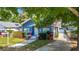 Charming home with manicured lawn, landscaped beds, and a brick chimney at 207 W Chelsea St, Tampa, FL 33603