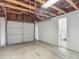 Spacious garage interior with exposed beams, providing ample storage and workspace for projects at 207 W Chelsea St, Tampa, FL 33603