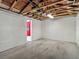 Empty garage with exposed wood rafters and concrete floor at 207 W Chelsea St, Tampa, FL 33603