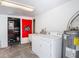 Functional laundry room with washer, dryer, utility sink, and water heater at 207 W Chelsea St, Tampa, FL 33603