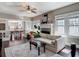 Spacious living area featuring a ceiling fan, fireplace, and large windows with natural light at 207 W Chelsea St, Tampa, FL 33603