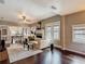 Bright living room with fireplace, windows and hardwood floors, open to a spacious kitchen and dining area at 207 W Chelsea St, Tampa, FL 33603