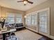 Well-lit home office with hardwood floors, modern furniture, and natural light from multiple windows at 207 W Chelsea St, Tampa, FL 33603