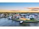 Stunning aerial view of a waterfront home at sunset, with a pool, private dock, and city skyline at 2087 Michigan Ne Ave, St Petersburg, FL 33703