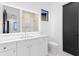 Modern bathroom featuring a white vanity, a large mirror, and a separate toilet at 2087 Michigan Ne Ave, St Petersburg, FL 33703