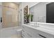 Modern bathroom featuring a sleek white vanity, contemporary art, and a glass-enclosed bathtub with shower at 2087 Michigan Ne Ave, St Petersburg, FL 33703