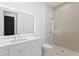Stylish bathroom showcasing a walk-in shower with neutral-toned tile and a modern white vanity with a large mirror at 2087 Michigan Ne Ave, St Petersburg, FL 33703