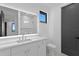 Modern bathroom featuring a white vanity, a large mirror, and a separate toilet at 2087 Michigan Ne Ave, St Petersburg, FL 33703