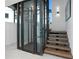Interior shot of a modern home showcasing an elevator, staircase, and sleek design elements at 2087 Michigan Ne Ave, St Petersburg, FL 33703