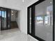 Spacious foyer with light tile floors, staircase, and large glass doors leading to a patio and waterfront views at 2087 Michigan Ne Ave, St Petersburg, FL 33703